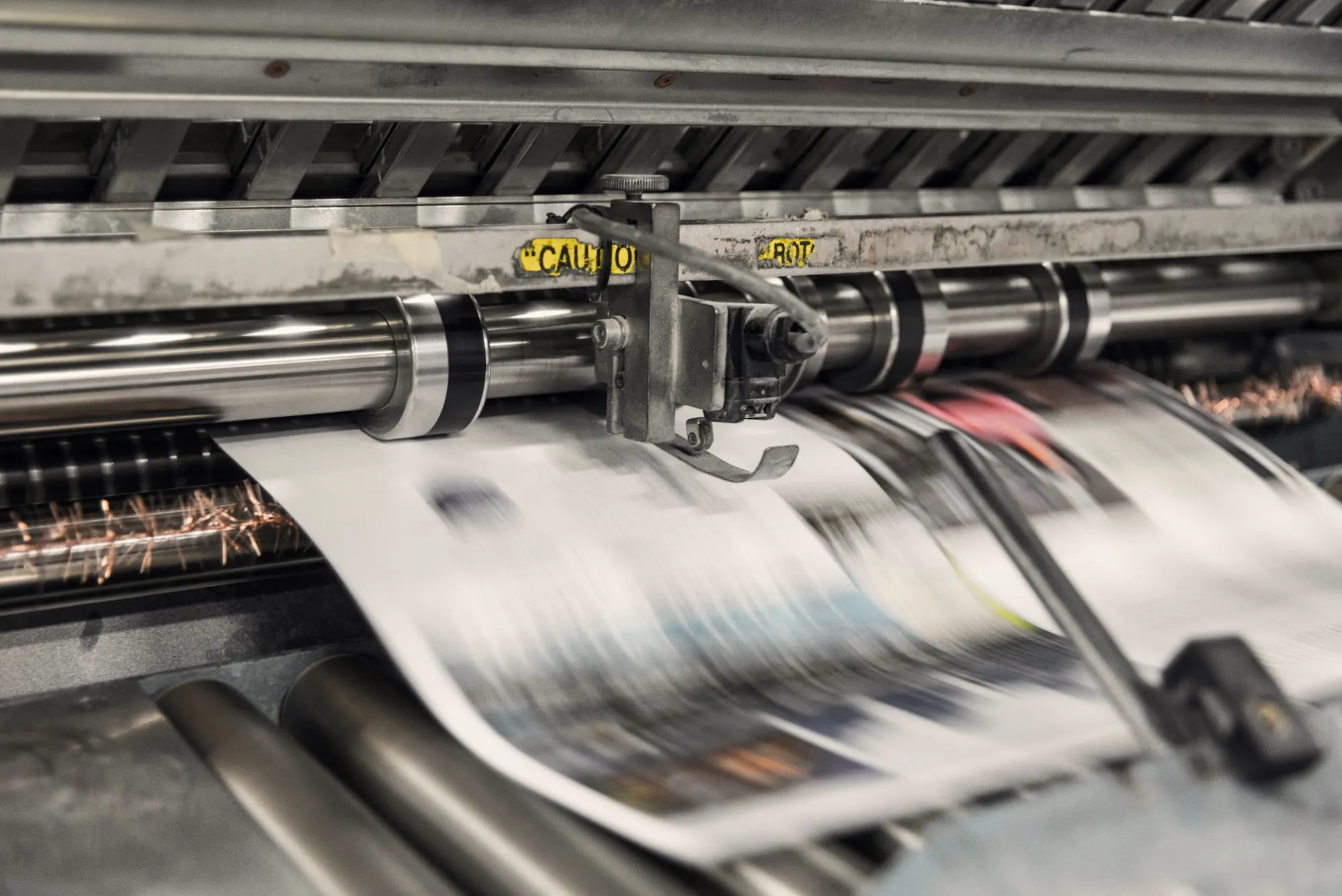 Newspapers running through a printing press